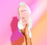 Method Pure Peace body wash 18 fl. oz. in a light pink bottle being held by a hand.